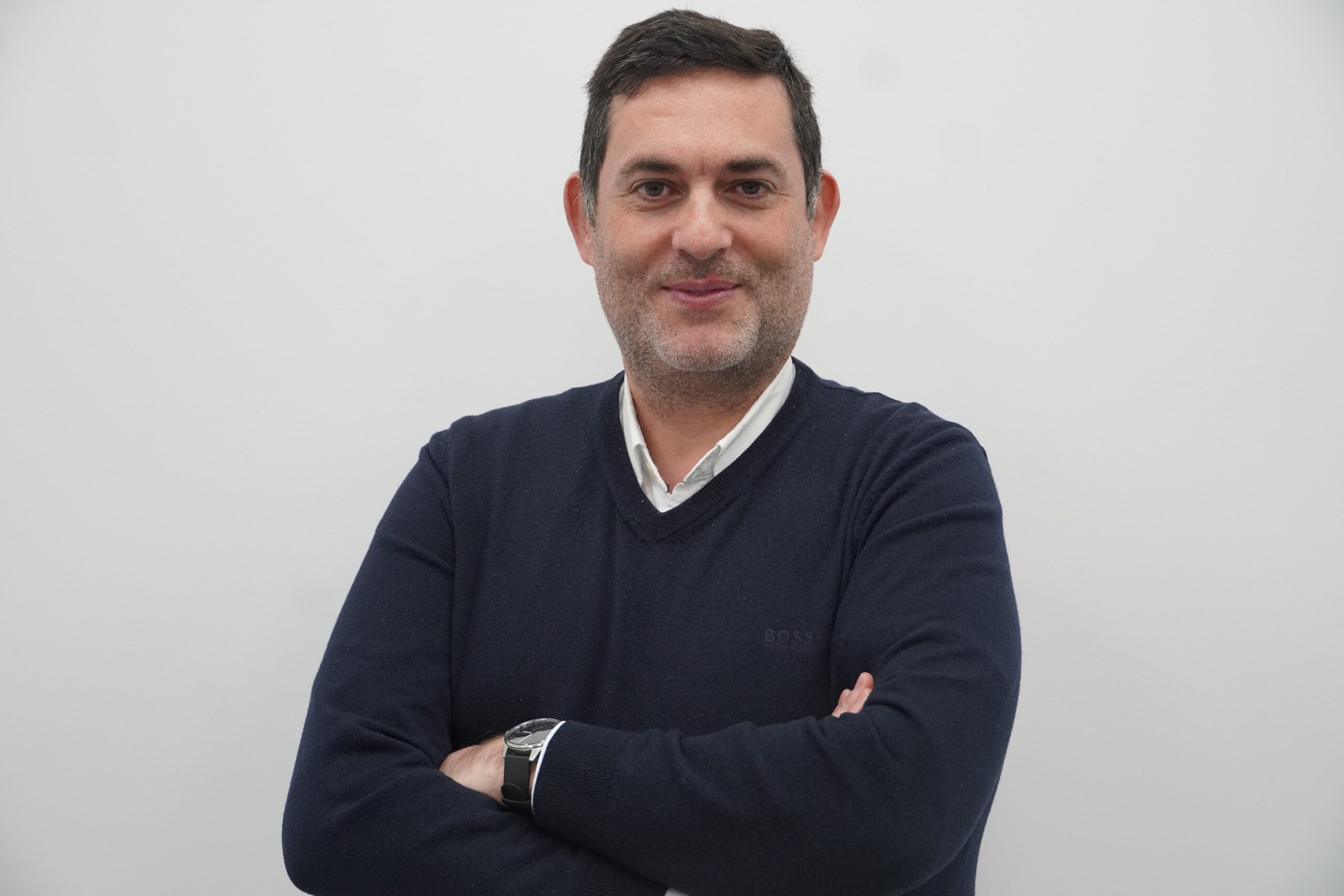 Man wearing a black shirt with arms-crossed.