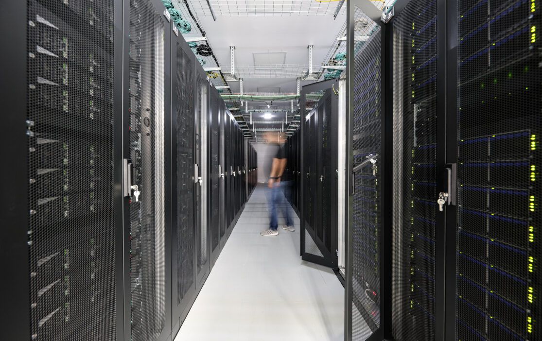 Deucalion supercomputer server corridor with a person in the middle of the corridor