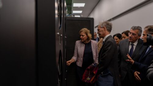 European officials visiting Deucalion supercomputer racks at CNCA, observing high-performance computing infrastructure.