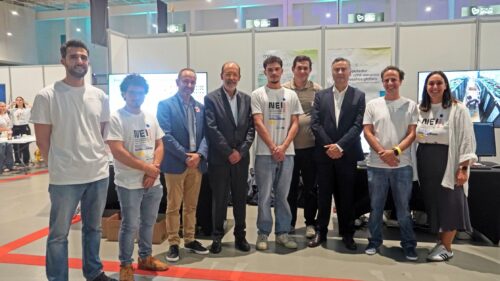 Group photo of the Deucalion team and institutional partners at the European Researchers’ Night stand, with exhibition materials and computing equipment in the background.