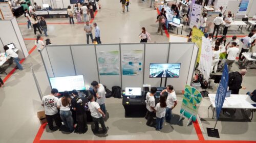 Aerial view of the European Researchers’ Night venue, showing multiple science stands, including Deucalion, with a high level of public attendance.