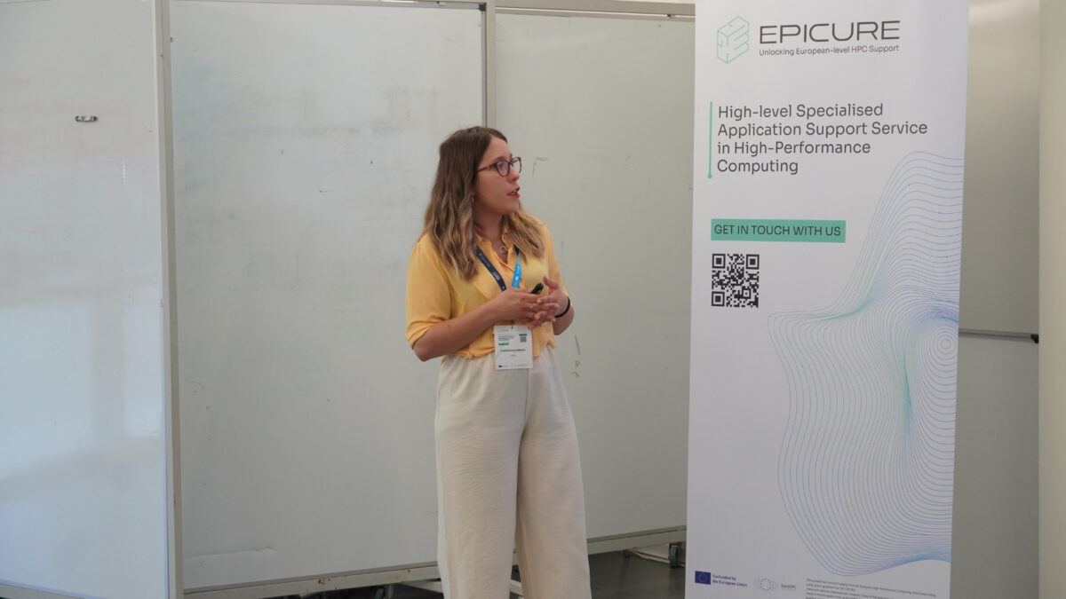 Orador a apresentar durante o hackathon do EPICURE ao lado de um roll-up a promover um serviços de suporte especializados em HPC, no INESC TEC.