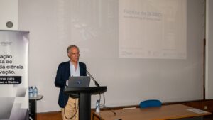 A speaker delivers a presentation on the BSC AI Factory initiative at a podium, with a projected slide outlining the project’s vision for accelerating AI innovation.