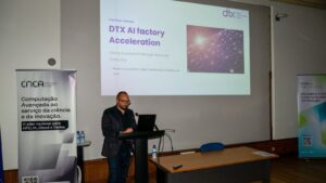 A man presents the DTX AI Factory Acceleration initiative at a CNCA event, with presentation slides displayed behind the podium.