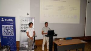 Two speakers present an AI-powered pet care platform at a CNCA event, introducing their solution with supporting presentation slides.